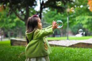 girl playing with bubble
