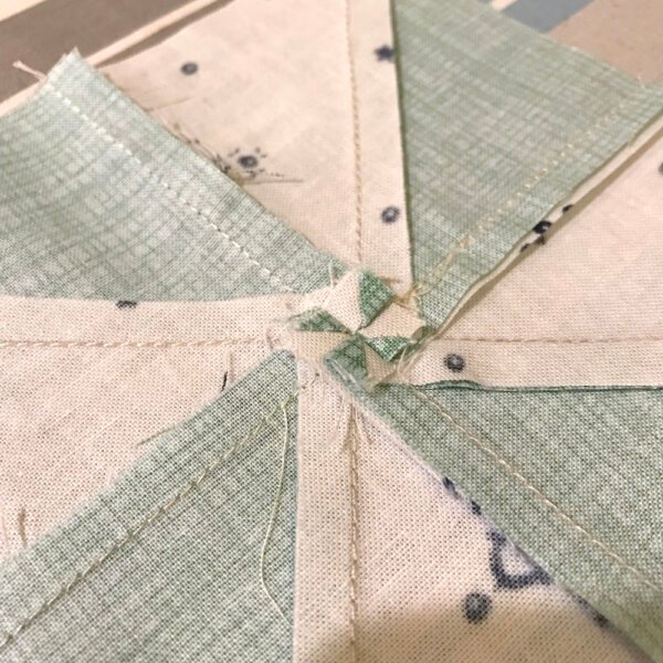 How to press a pinwheel block flat. How to reduce bulk in pinwheel seams.